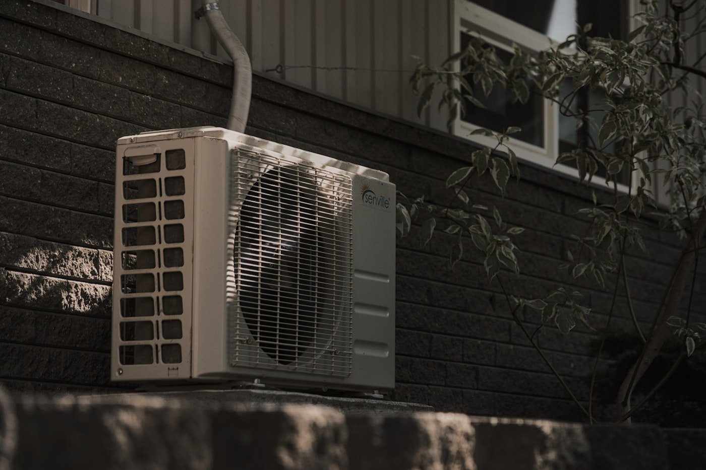 New central air conditioning unit installed beside a home